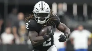 Ashton Jeanty, Las Vegas Raiders running back, running through the hole.